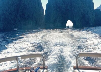 Passing by the Faraglioni of Capri during the boat tour.